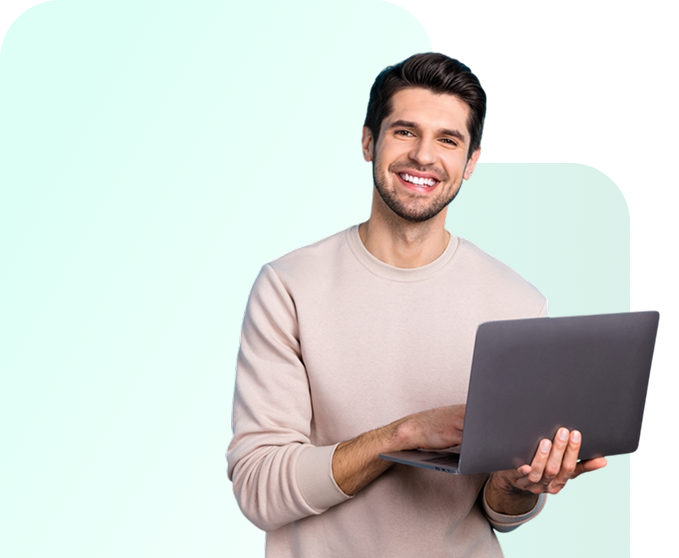 Smiling person using a gray laptop.
