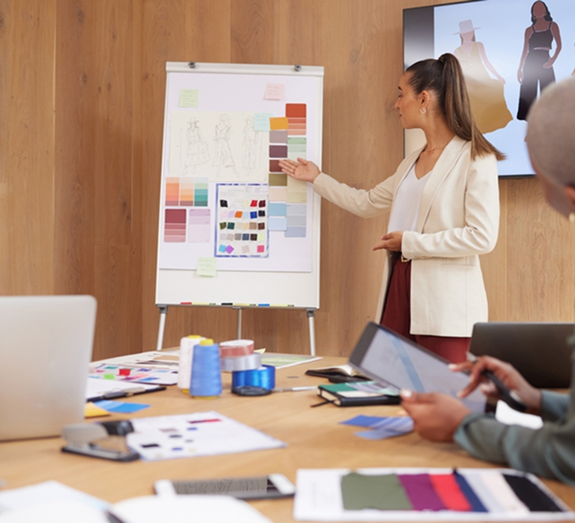 Fashion designer presenting color palettes in meeting.