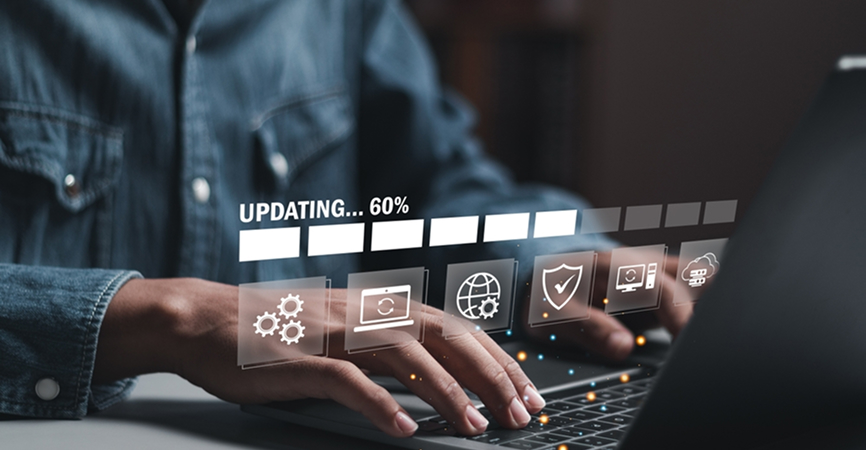 Person updating software on laptop, progress bar shown.